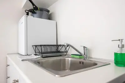 a kitchen sink with a basket on top of it at The Athenian Veranda 4 in Athens