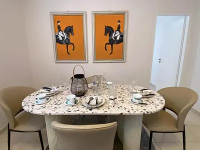 a dining room with a table with chairs and paintings at Versailles One Villa one-story suite in Metókhi