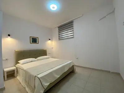 a bedroom with a bed in a white room at Versailles One Villa one-story suite in Metókhi