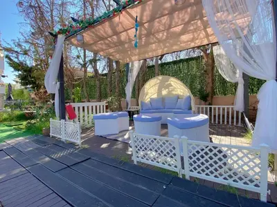 a gazebo with a table and chairs under it at Versailles One Villa one-story suite in Metókhi