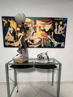 a glass table with a statue on top of it in front of a painting at Artistic & cozy ! Just 5' to seaside in Athens