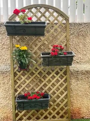 a wooden gate with two plants and flowers on it at Artistic & cozy ! Just 5' to seaside in Athens