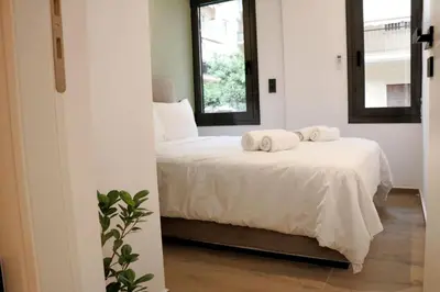 a bedroom with a bed with two towels on it at Theo Apartments in Athens Center in Athens