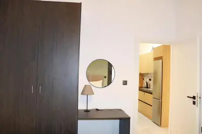 a hallway with a mirror and a table with a lamp at Theo Apartments in Athens Center in Athens
