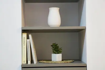 a shelf with a vase and a plant on it at Theo Apartments in Athens Center in Athens