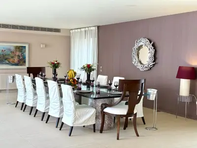 a dining room with a table and white chairs at Blue Angel Villa Luxury Seafront Estate in Porto Rafti
