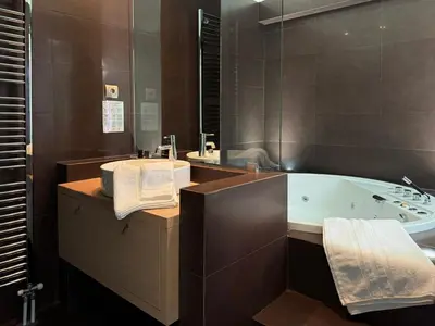 a bathroom with a tub and a large mirror at Blue Angel Villa Luxury Seafront Estate in Porto Rafti