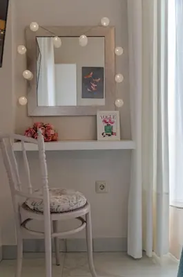 a mirror and a chair in a room at Green apartment in Piraeus