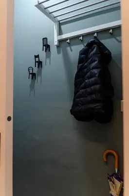 a room with two chairs and a black bag on the wall at Green apartment in Piraeus
