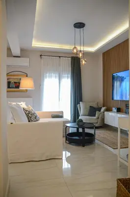 a living room with a couch and a table at Green apartment in Piraeus