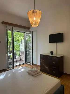 a bedroom with a bed with a dresser and a television at Kamara in Athens