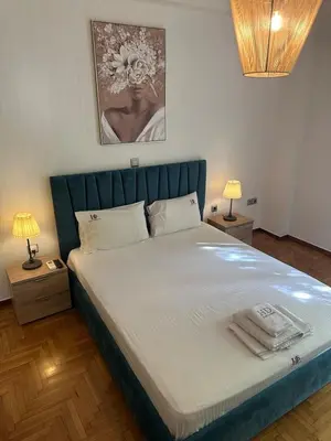 a bedroom with a large bed with a blue headboard at Kamara in Athens