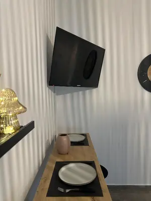 a room with a table with a tv on the wall at Kamara in Athens