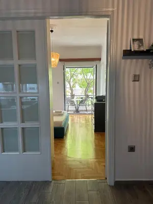 a room with a door open to a living room at Kamara in Athens