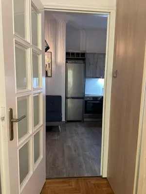 a door leading to a living room with a television at Kamara in Athens