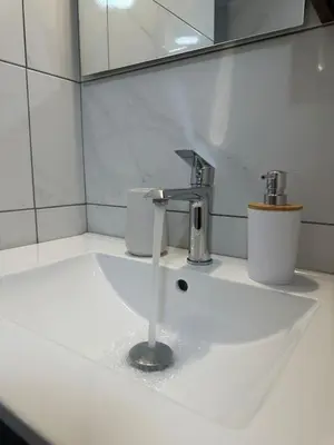 a bathroom sink with water coming out of it at Kamara in Athens