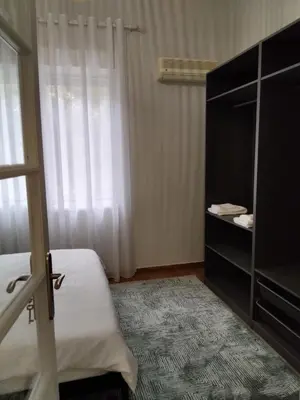a bedroom with a bed and a dresser and a window at my HOME in Athens