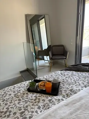 a tray of food on a bed in a room at Kallitheas Maison with Shared Pool in Athens
