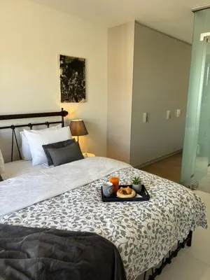 a bed with a tray of food on it at Kallitheas Maison with Shared Pool in Athens