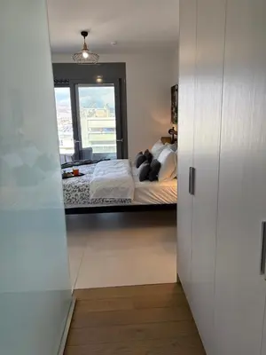 a bedroom with a bed and a window at Kallitheas Maison with Shared Pool in Athens