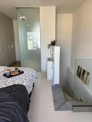 a bedroom with a bed with a tray of food on it at Kallitheas Maison with Shared Pool in Athens
