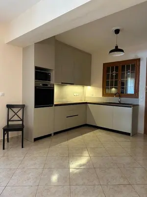 an empty kitchen with a sink and a stove at Villa Isidora Luxe in Kalívia Thorikoú