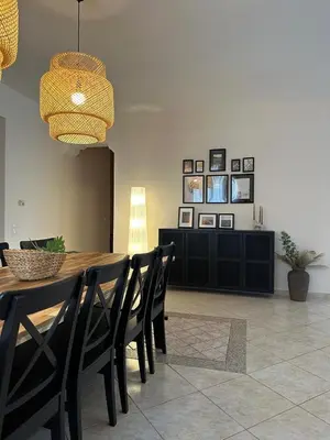 a dining room with a wooden table and chairs at Villa Isidora Luxe in Kalívia Thorikoú