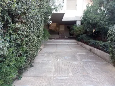 a hallway of a building with a green hedge at 2BD apartment with large balcony near the sea!! in Athens