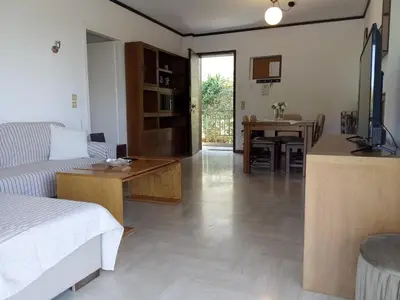 a living room with a couch and a table and a kitchen at 2BD apartment with large balcony near the sea!! in Athens