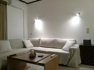 a living room with a couch and a coffee table at 2BD apartment with large balcony near the sea!! in Athens