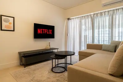 a living room with a couch and a tv at Elegant Suite - Koukaki in Athens