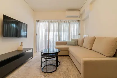 a living room with a couch and a table at Elegant Suite - Koukaki in Athens