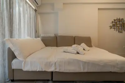 a bed with two pillows on it in a room at Elegant Suite - Koukaki in Athens