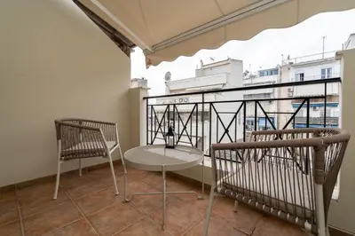 a table and chairs on a balcony with a view at Elegant Suite - Koukaki in Athens