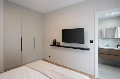a living room with a tv on a wall at Upscale Apartment in Chalandri with Large Terrace in Athens