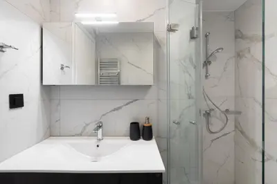 a bathroom with a sink and a shower at Upscale Apartment in Chalandri with Large Terrace in Athens
