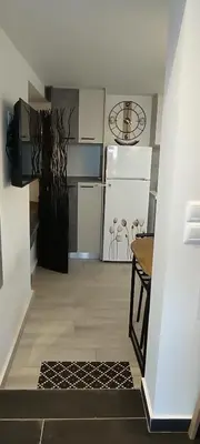 a kitchen with a refrigerator and a table in it at Homeyfeel StayTOP - ΑΡΓΥΡΟΥΠΟΛΗ - ΕΛΛΗΝΙΚΟ in Athens