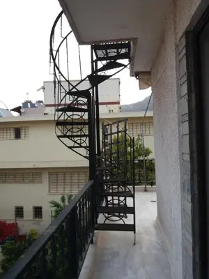 a spiral staircase on the side of a building at Homeyfeel StayTOP - ΑΡΓΥΡΟΥΠΟΛΗ - ΕΛΛΗΝΙΚΟ in Athens