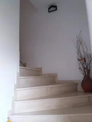a set of stairs with a vase on the floor at Homeyfeel StayTOP - ΑΡΓΥΡΟΥΠΟΛΗ - ΕΛΛΗΝΙΚΟ in Athens