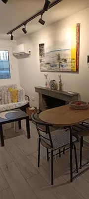 a living room with a table and a couch at Homeyfeel StayTOP - ΑΡΓΥΡΟΥΠΟΛΗ - ΕΛΛΗΝΙΚΟ in Athens