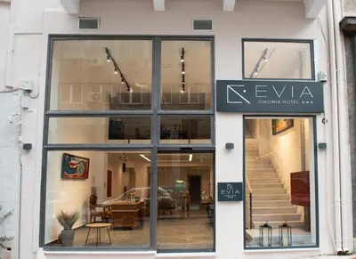 a store front with a sign for a furniture store at Evia Hotel in Athens