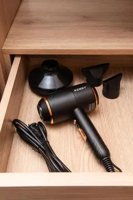 a black flashlight sitting in a wooden drawer at Evia Hotel in Athens
