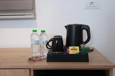 a coffee maker and water bottles on a counter at Evia Hotel in Athens