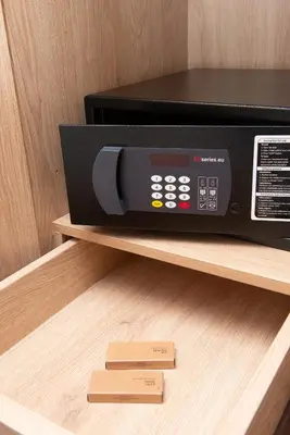 a black microwave on a shelf in a cabinet at Evia Hotel in Athens