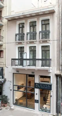 a building with a sign in front of it at Evia Hotel in Athens