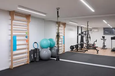 a gym with exercise equipment and balloons in a room at Ema's Guest House in Porto Rafti