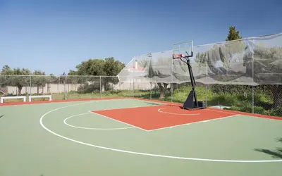 a basketball hoop on a tennis court at Ema's Guest House in Porto Rafti