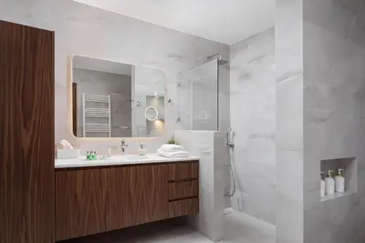 a bathroom with a sink and a shower with a mirror at Ema's Guest House in Porto Rafti