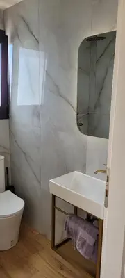a white bathroom with a sink and a toilet at The Penthouse in Athens