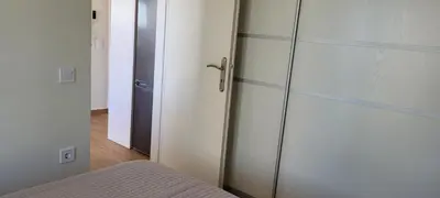 a bedroom with a glass cabinet next to a bed at The Penthouse in Athens